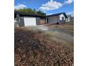 View of home with an attached garage and long driveway at 10336 Oak Hill Dr, Port Richey, FL 34668
