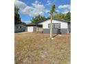 View of the home and palm tree in the yard at 10336 Oak Hill Dr, Port Richey, FL 34668