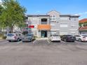 Condo building with ample parking, terracotta tile roofing, and well-maintained facade with an inviting entryway at 18001 Richmond Place Dr # 126, Tampa, FL 33647