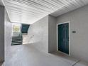 Exterior hallway leading to unit #126 with covered stairs and textured walls, offering a private entrance at 18001 Richmond Place Dr # 126, Tampa, FL 33647