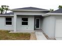 A close-up view of the home's front entrance, showcasing a covered porch and modern design at 4146 New Milford St, North Port, FL 34288