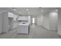 Spacious kitchen featuring white cabinetry, a large island, and stainless steel appliances at 4146 New Milford St, North Port, FL 34288