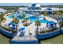 Stunning aerial view of the community pool area with cabanas, lounge chairs, and manicured landscaping at 5820 Shorebird Br, Land O Lakes, FL 34638