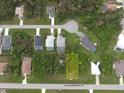 An aerial view showcasing a lot surrounded by lush trees in a tranquil residential neighborhood at 487 Sunset N Rd, Rotonda West, FL 33947