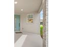 Welcoming front porch area, with stone pillar, offering an inviting entry into the home at 6026 Jensen View Ave, Apollo Beach, FL 33572