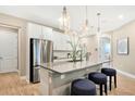 Modern kitchen featuring white cabinets, stainless steel appliances, and a spacious center island at 9136 Players Dr, Weeki Wachee, FL 34613