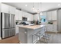 Bright, modern kitchen features stainless steel appliances and a center island with seating at 9156 Players Dr, Weeki Wachee, FL 34613