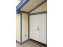 Welcoming entryway featuring a white double door with a glass panel and a beige and blue trim at 7314 Patio Row, Hudson, FL 34667