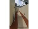 Narrow side yard with rock covering ground at 7314 Patio Row, Hudson, FL 34667