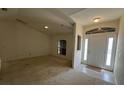 Welcoming foyer with tile flooring, window, and a view into the living area at 2305 De Vore St, North Port, FL 34291