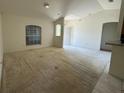 Spacious living room featuring neutral paint, vaulted ceilings, and natural light at 2305 De Vore St, North Port, FL 34291