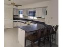 Bright kitchen features white cabinets, blue-gray countertops and modern design at 5905 Cleveland Dr, Punta Gorda, FL 33982