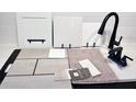 Close up of interior design materials showing tile, carpet, granite, and cabinet samples at 6038 Jensen View Ave, Apollo Beach, FL 33572
