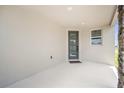 Covered porch with a modern front door featuring vertical window panes at 6042 Jensen View Ave, Apollo Beach, FL 33572