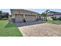 Lovely single-story home with a brick driveway and a two-car garage at 5497 56Th E Ct, Bradenton, FL 34203