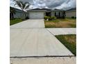 Inviting single-story home with a two-car garage, an expansive driveway, and freshly landscaped front yard at 17130 11Th Ter E, Bradenton, FL 34212