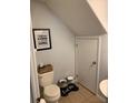 Cozy bathroom with a toilet, sink, and humorous wall art, plus convenient pet feeding station at 9871 Trumpet Vine Loop, Trinity, FL 34655