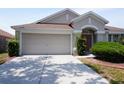 Well maintained home exterior with spacious driveway, manicured bushes and two-car garage at 10308 Soaring Eagle Dr, Riverview, FL 33578