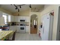 Bright kitchen featuring white cabinetry, tile floors, and modern appliances at 10308 Soaring Eagle Dr, Riverview, FL 33578