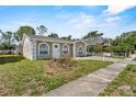 Attractive single-story house showcasing arched windows, and a concrete pathway leading to the front door at 4408 W Prescott St, Tampa, FL 33616