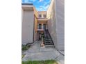 Low angle image of a two-story condo with neutral-toned siding and exterior staircases at 5151 Puritan Cir # 1022, Tampa, FL 33617