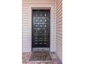 Charming front door with decorative panels and a welcoming 'Come in and Cozy up' doormat at 5151 Puritan Cir # 1022, Tampa, FL 33617