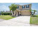 Attractive two-story home boasting a neatly kept lawn, an attached two-car garage, and lush landscaping at 2746 Walden Woods Dr, Plant City, FL 33566