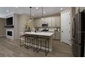 Stylish kitchen with island seating, modern appliances, and pendant lighting, creating an inviting culinary space at 9058 Players Dr, Weeki Wachee, FL 34613