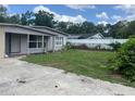Back yard with a well-maintained lawn, and privacy fence showing the outdoor area at 1009 Kenmore Dr, Brandon, FL 33510