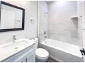 The bathroom features a tub shower combo with modern tile surround, vanity and a framed mirror at 17381 Tyler Ave, Port Charlotte, FL 33948
