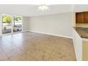 Spacious living room with tile flooring and access to the balcony with natural light at 2700 Coconut Bay Ln # 419, Sarasota, FL 34237