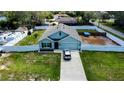 Aerial view of a light blue single-Gathering home with a large, partially fenced backyard at 6315 Hillview Rd, Spring Hill, FL 34606