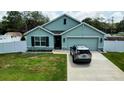 Charming single-story home with a two-car garage, manicured lawn, and tasteful landscaping at 6315 Hillview Rd, Spring Hill, FL 34606