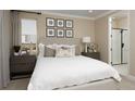 Serene bedroom featuring neutral tones, stylish furniture, and an ensuite bathroom at 9275 Players Dr, Weeki Wachee, FL 34613