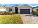 Beautiful single-Gathering home with well-manicured landscaping and a paved driveway at 11330 Burgundy Dr, Venice, FL 34293