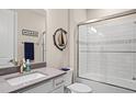 Well-lit bathroom featuring a shower over tub, white subway tile, and modern fixtures at 6288 Winding Pine Dr, Nokomis, FL 34275