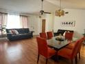 Bright living and dining area with hardwood floors, modern lighting, and comfortable seating at 12322 Alta Mira St, North Port, FL 34287
