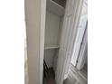 A view of an empty closet, with a shelf, in the interior of the house at 147 Melanie Ln, Brandon, FL 33510