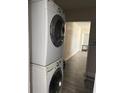 Efficient laundry area featuring a stacked washer and dryer set at 147 Melanie Ln, Brandon, FL 33510