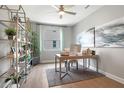 Bright and airy home office with modern decor, ample workspace, and stylish shelving at 9211 Players Dr, Weeki Wachee, FL 34613