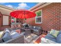 Back patio with cozy outdoor seating area and an umbrella, ideal for relaxing or entertaining guests at 2601 Upton S St, Gulfport, FL 33711