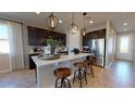 Modern kitchen featuring a center island, stainless steel appliances, and pendant lighting at 9127 Players Dr, Weeki Wachee, FL 34613