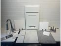 Selection of interior design samples, including a faucet, counter, tile, and cabinet door at 9127 Players Dr, Weeki Wachee, FL 34613