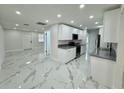 Open concept kitchen with marble tile floors, granite countertops and new stainless steel appliances at 390 Hazel Cir, Punta Gorda, FL 33982
