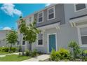 Charming townhome with manicured landscaping and a modern gray and white facade at 8540 Daybreak St, Sarasota, FL 34241