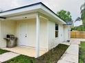 Exterior view showcasing a cozy covered patio and outdoor grill, perfect for entertaining guests at 801 Leeward Way, Palm Harbor, FL 34685