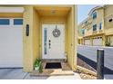 Front entrance with decorative wreath and adjacent garage door at 1061 Pinellas Bayway S, Tierra Verde, FL 33715
