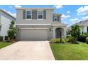 Charming two-story home with stone accents, a two-car garage, and landscaped front yard at 3255 Hilltop Cir, Bradenton, FL 34211