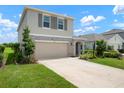 Inviting two-story home with a two-car garage and beautifully landscaped front yard at 3255 Hilltop Cir, Bradenton, FL 34211