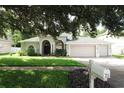 Charming single Gathering home with a well-maintained lawn, mature landscaping, and a three car garage at 4428 Winding River Drive, Valrico, FL 33596